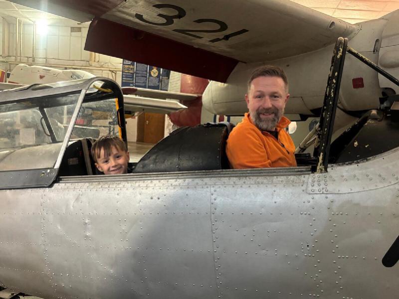 My grandson and me sitting in the cockpit of a vintage aircraft at South Wales Aviation Museum