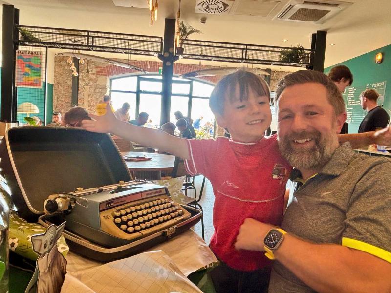 With my grandson and the typewriter that came home with us